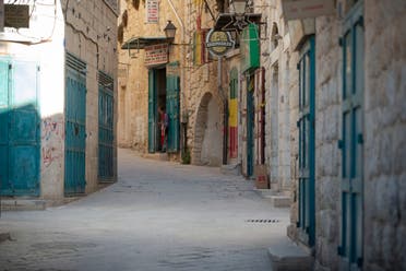 A Palestinian vendor stands in front of his shop near the Church of the Nativity, traditionally believed to be the birthplace of Jesus Christ, in the West Bank City of Bethlehem, Monday, November 23, 2020. (The Associated Press/Majdi Mohammed)