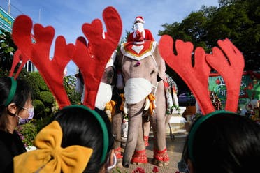 Mahouts dress elephants as Santa Claus to help distribute face masks to students, in an effort to help prevent the spread of the coronavirus disease (COVID-19), ahead of Christmas celebrations at a school in Ayutthaya, Thailand, December 23, 2020. (Reuters/Chalinee Thirasupa)