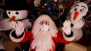 A Santa Claus gestures at a Christmas set, in Guadalajara in the state of Jalisco, Mexico, on December 20, 2020, amid the COVID-19 coronavirus pandemic. (AFP)