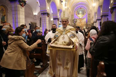 Apostolic Administrator of the Latin Church in the Holy land Pierbattista Pizzaballa, center, leads a Christmas midnight mass at the Church of the Nativity in the West Bank city of Bethlehem on Friday, Dec. 25, 2020. It is traditionally believed by Christians that the Church of the Nativity was the birthplace of Jesus Christ. (Abed Al Hashlamoun/Pool Photo via AP)