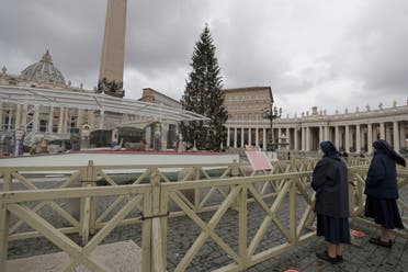 Nuns stand in front of the Nativity scene prior to the start of Pope Francis' Urbi et Orbi message (Latin for 'to the city and to the world' ) on Christmas' day in St. Peter's Square, at the Vatican, Friday, Dec. 25, 2020. (AP Photo/Gregorio Borgia)