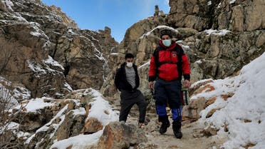 People wearing protective masks hike at the Darakeh mountainous area, north of the capital Tehran, Iran, Friday, Dec 25, 2020. (AP/Ebrahim Noroozi)