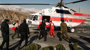 Rescuers work to unload bags containing bodies of mountaineers who died after avalanches in a mountainous area north of the capital Tehran, Iran. (AP)