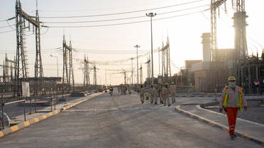Employees walk the ground of the Dhi Qar Combined Cycle Power Plant near the Iraqi city of Nasiriyah. (AFP)