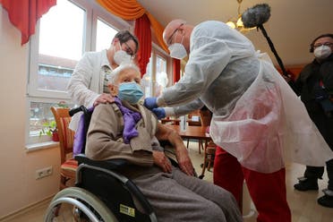 Edith Kwoizalla, 101 years old, receives the first vaccination against COVID-19 by Pfizer and BioNTech from Doctor Bernhard Ellendt (R) in a senior care facility in Halberstadt, central northern Germany, on December 26, 2020. (Matthias Bein/dpa/AFP)