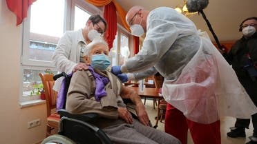 Edith Kwoizalla, 101 years old, receives the first vaccination against COVID-19 by Pfizer and BioNTech from Doctor Bernhard Ellendt (R) in a senior care facility in Halberstadt, central northern Germany, on December 26, 2020. (Matthias Bein/dpa/AFP)