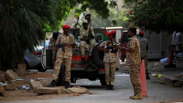 Sudanese soldiers secure the area as Sudan's ex-president Omar al-Bashir leaves the office of the anti-corruption prosecutor in Khartoum. (Reuters)