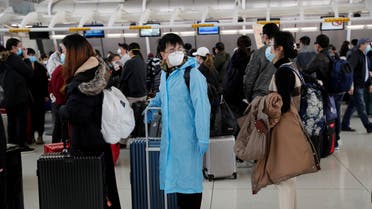 Passengers waiting to check in for an Air China flight are seen with face masks on, after further cases of coronavirus were confirmed in New York, at JFK International Airport in New York. (Reuters)