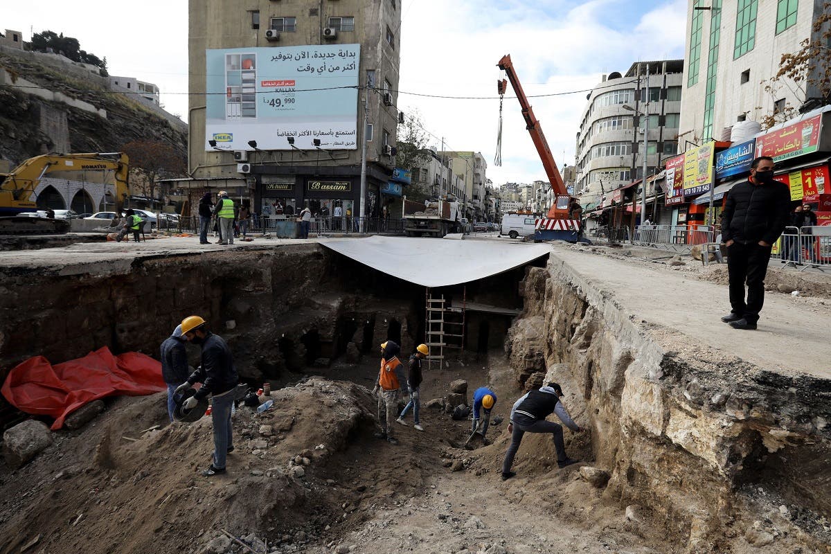 Archaeologists and workers excavate at a Roman archaeological site discovered during works to install a water drainage system, in downtown Amman, Jordan, on December 27, 2020. (Reuters)