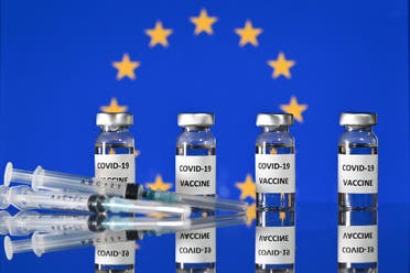 Vials with Covid-19 Vaccine stickers attached, and syringes, with a flag of the European Union. (AFP)