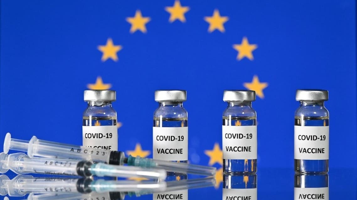 This illustration photo taken on November 17, 2020 shows vials with Covid-19 Vaccine stickers attached, and syringes, with a flag of the European Union. (AFP)