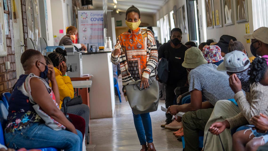 Volunteers wait to be checked at a vaccine trial facility set at Soweto's Chris Sani Baragwanath Hospital outside Johannesburg, South Africa, Monday Nov. 30, 2020. Over 2000 South African volunteers are on AstraZeneca's experimental coronavirus vaccine trial. (AP Photo/Jerome Delay)