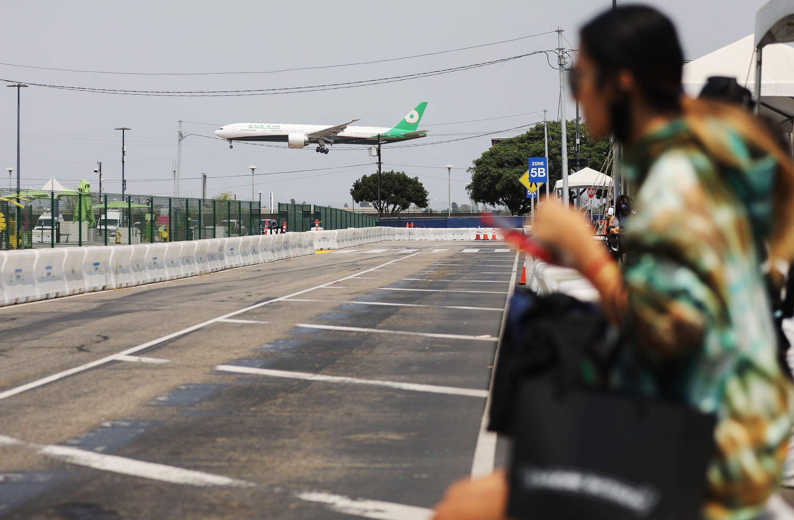 An EVA Air flight lands near a Lyft pickup area at Los Angeles International Airport (LAX) on August 20, 2020. (AFP)