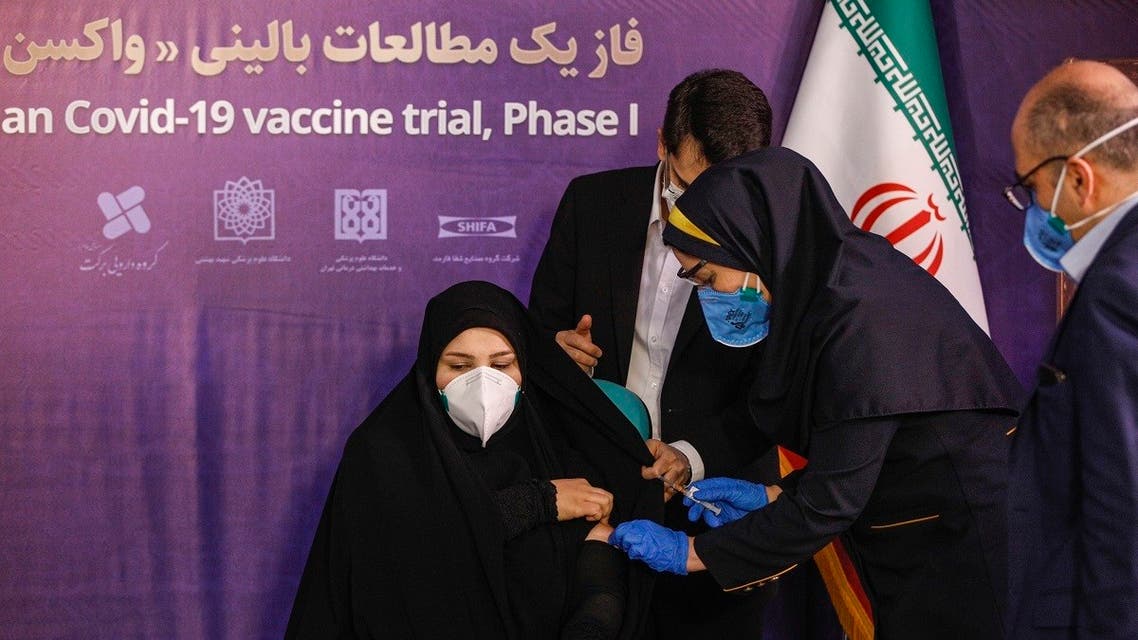A woman receives an injection during the first trial phase of a locally-made Iranian vaccine for COVID-19 coronavirus disease in Iran's capital Tehran on December 29, 2020. (AFP)