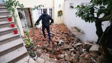 A man walks over debris after an earthquake, in Zagreb, Croatia December 29, 2020. (Reuters)