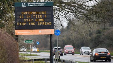 Vehicles drive past a roadside public health information sign, amidst the spread of the coronavirus pandemic, near Oxford, Britain, on December 28, 2020. (Reuters)