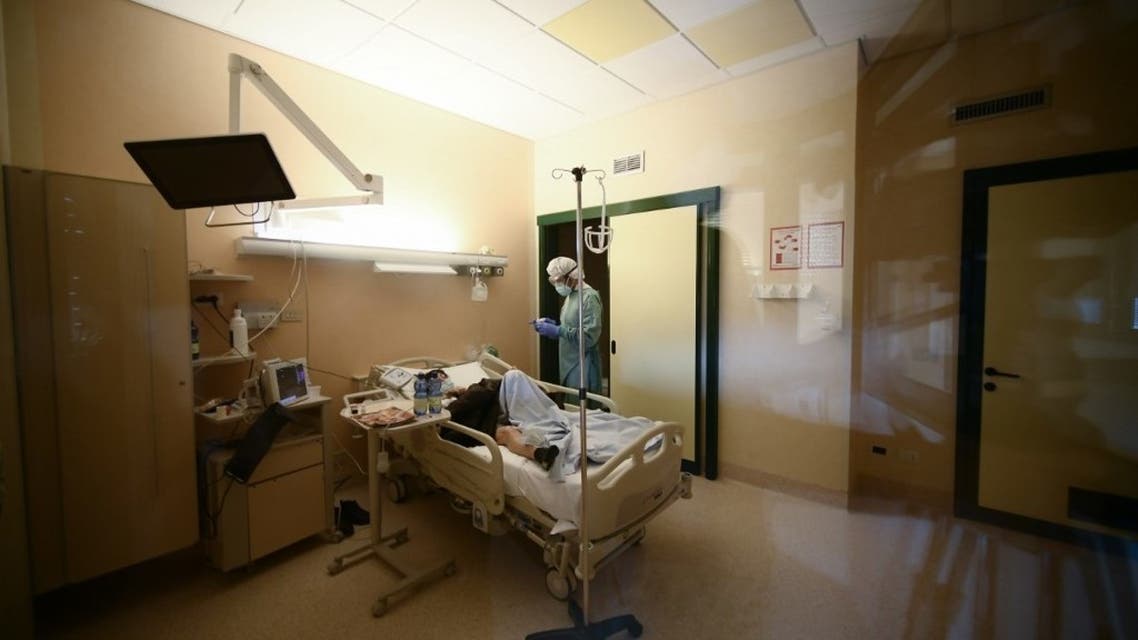 A medical worker tends to a patient in the sub-intensice care unit of the Tor Vergata hospital in Rome on December 21, 2020, during the COVID-19 pandemic caused by the novel coronavirus. (AFP)