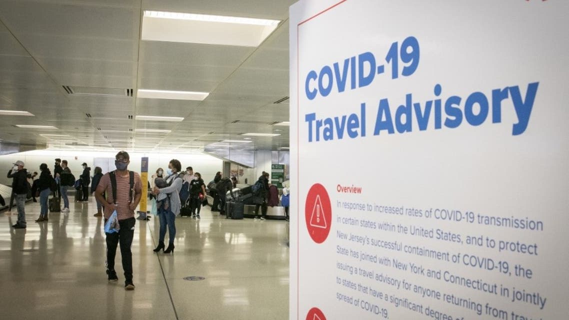 In this file photo taken on November 21, 2020 travelers wait for their luggage at Newark International Airport in Newark, New Jersey. (AFP)