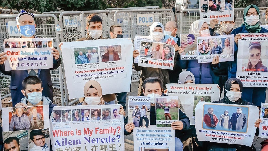 Members of the Muslim Uighur minority hold placards as they demonstrate in front of the Chinese consulate on December 30, 2020, in Istanbul, Turkey. (Bulent Kilic/AFP)