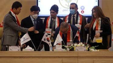 Iraq’s director general at the General Company for Ports, Farhan al-Fartousi, signs a contract with South Korea?s Daewoo Engineering & Construction, to construct the Grand Faw port, Baghdad, Iraq, December 30, 2020. (Reuters/Khalid al-Mousily)