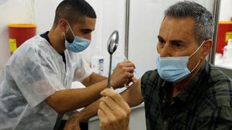 Mystic Geller joins Israel vaccine drive performing his trademark spoon-bending trick