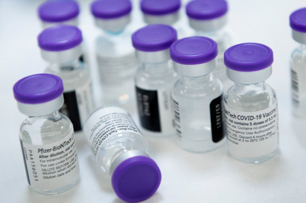 Vials of undiluted Pfizer COVID-19 vaccine are prepared to administer to staff and residents at the Goodwin House Bailey's Crossroads, a senior living community in Falls Church, Virginia, on December 30, 2020. (AFP)