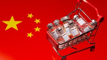 A small shopping basket filled with vials labeled COVID-19 - Coronavirus Vaccine is placed on a Chinese flag in this illustration taken November 29, 2020. (Reuters)