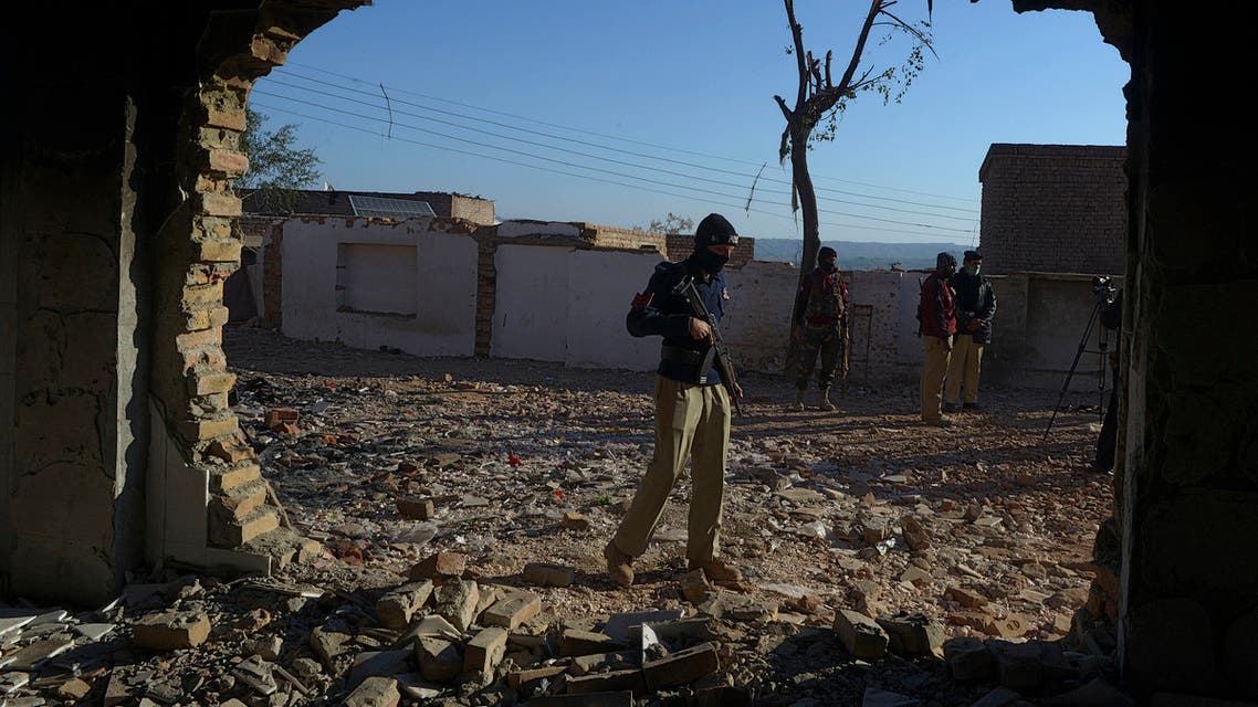 A policeman stands guard at the burnt Hindu temple a day after a mob attack in a remote village in Karak district, some 160 kms southeast of Peshawar on December 31, 2020. Hundreds of Muslims attacked and set fire to a Hindu temple in northwest Pakistan on December 30, police and witnesses said. Abdul MAJEED / AFP