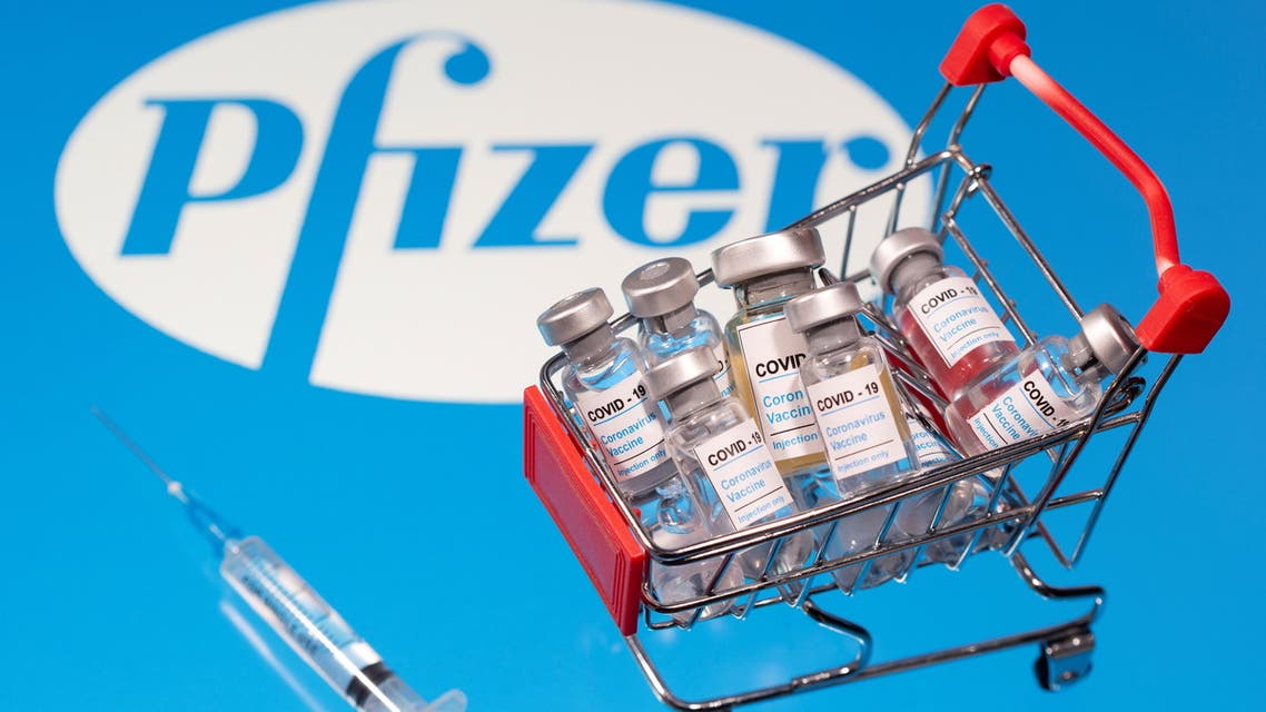 A small shopping basket filled with vials labeled COVID-19 - Coronavirus Vaccine and a medical sryinge are placed on a Pfizer logo in this illustration taken November 29, 2020. (Reuters)