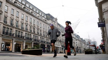 People jog down almost empty Regent Street in New Year's Day amid the coronavirus outbreak, in London, Britain, on January 1, 2021. (Reuters)