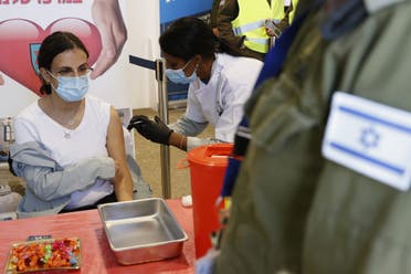 An Israeli military medic gets vaccinated against the COVID-19 coronavirus at the medical centre of Tzrifin military base in the Israeli town of Rishon Lezion on December 28, 2020. (AFP)