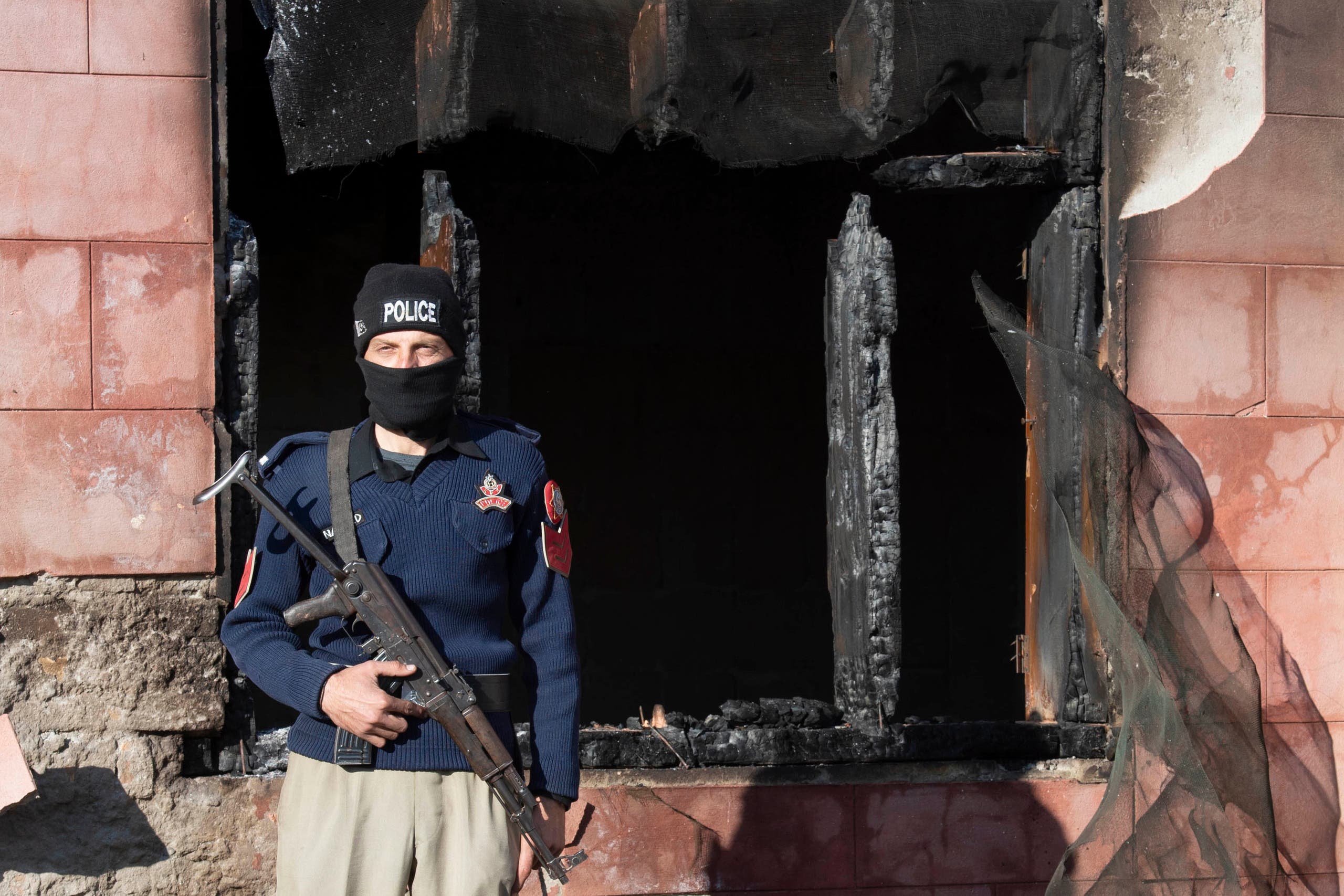 A policeman stands guard at the burnt Hindu temple a day after a mob attack in a remote village in Karak district, some 160 kms southeast of Peshawar on December 31, 2020. (AFP)