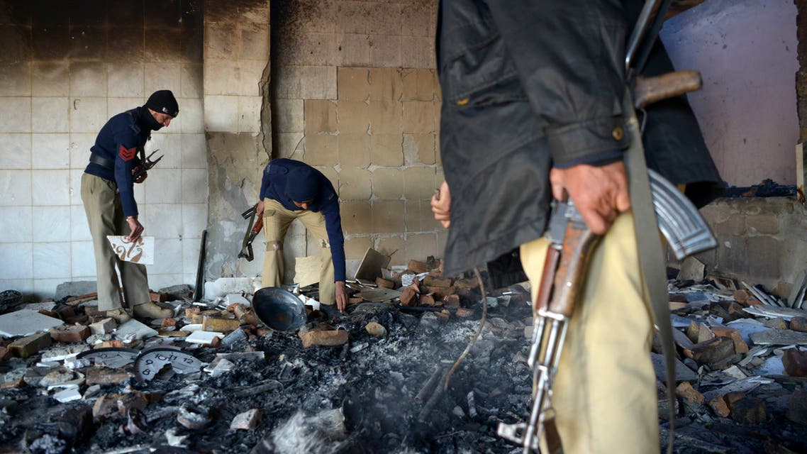 Policemen inspect the burnt Hindu temple a day after a mob attack in a remote village in Karak district on December 31, 2020. (AFP)