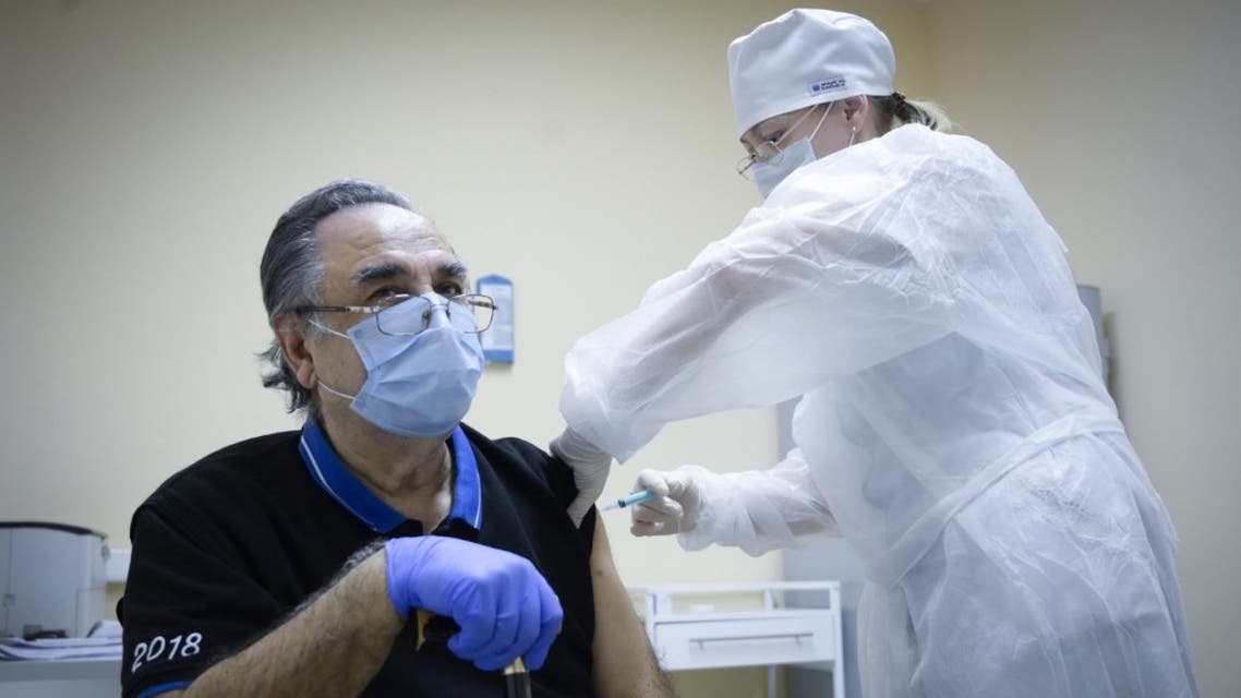 A nurse vaccinates Georgiy Stepanov, 82, with the Sputnik V (Gam-COVID-Vac) Covid-19 vaccine at a clinic in Moscow, on December 30, 2020. (AFP)