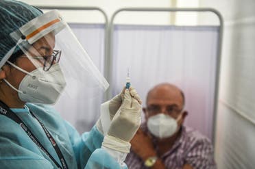 A health worker prepares a syringe to inoculate a volunteer with a COVID-19 vaccine produced by the Chinese Sinopharm during its trial at the Clinical Studies Center of the Cayetano Heredia University in Lima on December 09, 2020. (AFP)