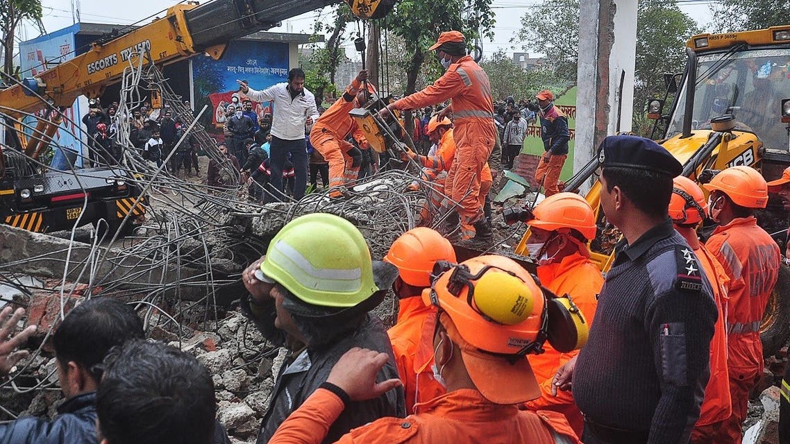 National Disaster Response Force (NDRF) personnel perform a search and rescue operation after a roof of a shelter at a cremation ground collapsed, in Ghaziabad on January 3, 2021. (STR/AFP)