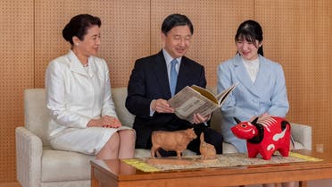 Japan’s Emperor Naruhito (C) talking with Empress Masako (L) and their daughter Princess Aiko (R) during a family portrait session for the New Year at their Akasaka Estate residence in Tokyo. (The Imperial Household Agency of Japan/AFP)