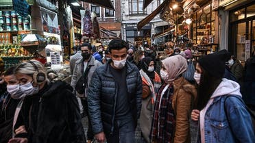 People wear face masks during shopping to prevent the spread of the Covid-19 caused by the novel coronavirus at Eminonu in Istanbul, on December 14, 2020. (Ozan Kose/AFP)