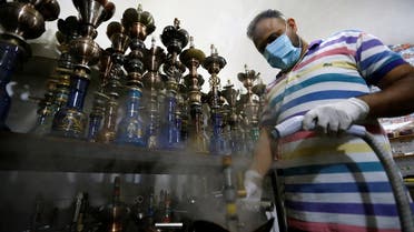 A worker disinfects shisha, amid the outbreak of the coronavirus disease (COVID-19), at al-Faisaliah Cafe in Baghdad, Iraq. (File photo: Reuters)