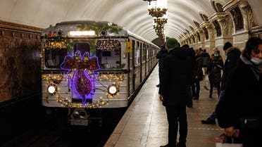 A metro train decorated with Christmas lights arrives at Belorusskaya metro station in Moscow . (AFP)