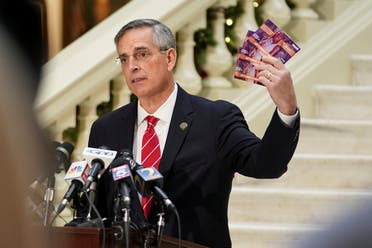 Georgia's Secretary of State Brad Raffensperger holds up election mail that he said arrived for his son, who is deceased, during a news conference on election results in Atlanta, Georgia. (Reuters)