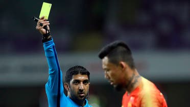   Referee Mohammed Abdulla Hassan, left, shows a yellow card to China's defender Zhang Linpeng during the AFC Asian Cup round of 16 soccer match between Thailand and China at the Hazza Bin Zayed stadium in Al Ain, United Arab Emirates, Sunday, January 20, 2019. (AP Photo)
