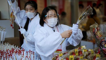 Staff members of a Shinto shrine prepare to sell lucky charms on the first business day of the New Year at the Kanda Myojin shrine amid the coronavirus disease outbreak in Tokyo, Japan, January 4, 2021. (Reuters/Issei Kato)