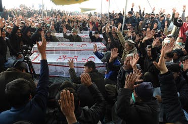 Mourners from Shia Hazara community chant slogans near the coffins of the miners during a sit-in protest. (AFP)