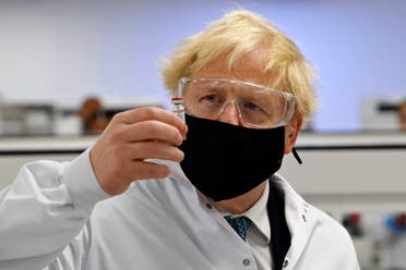 Britain's Prime Minister Boris Johnson holds a vial of the Oxford/AstraZeneca vaccine Covid-19 on Monday November 30, 2020. (Paul Ellis/PA via AP)