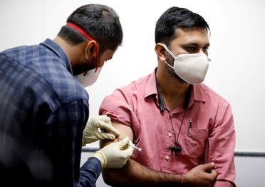 A medic administers COVAXIN, an Indian government-backed experimental COVID-19 vaccine, to a health worker during its trials, at the Gujarat Medical Education & Research Society in Ahmedabad, India, on November 26, 2020. (Reuters)