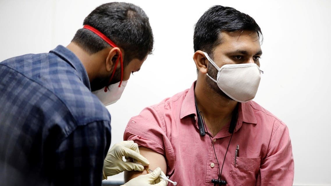 A medic administers COVAXIN, an Indian government-backed experimental COVID-19 vaccine, to a health worker during its trials, at the Gujarat Medical Education & Research Society in Ahmedabad, India, on November 26, 2020. (Reuters)