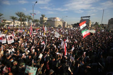 Iraqi demonstrators rally in Tahrir square in Baghdad on January 3, 2021, to mark the anniversary of the death of Qasem Soleimani. (AFP)