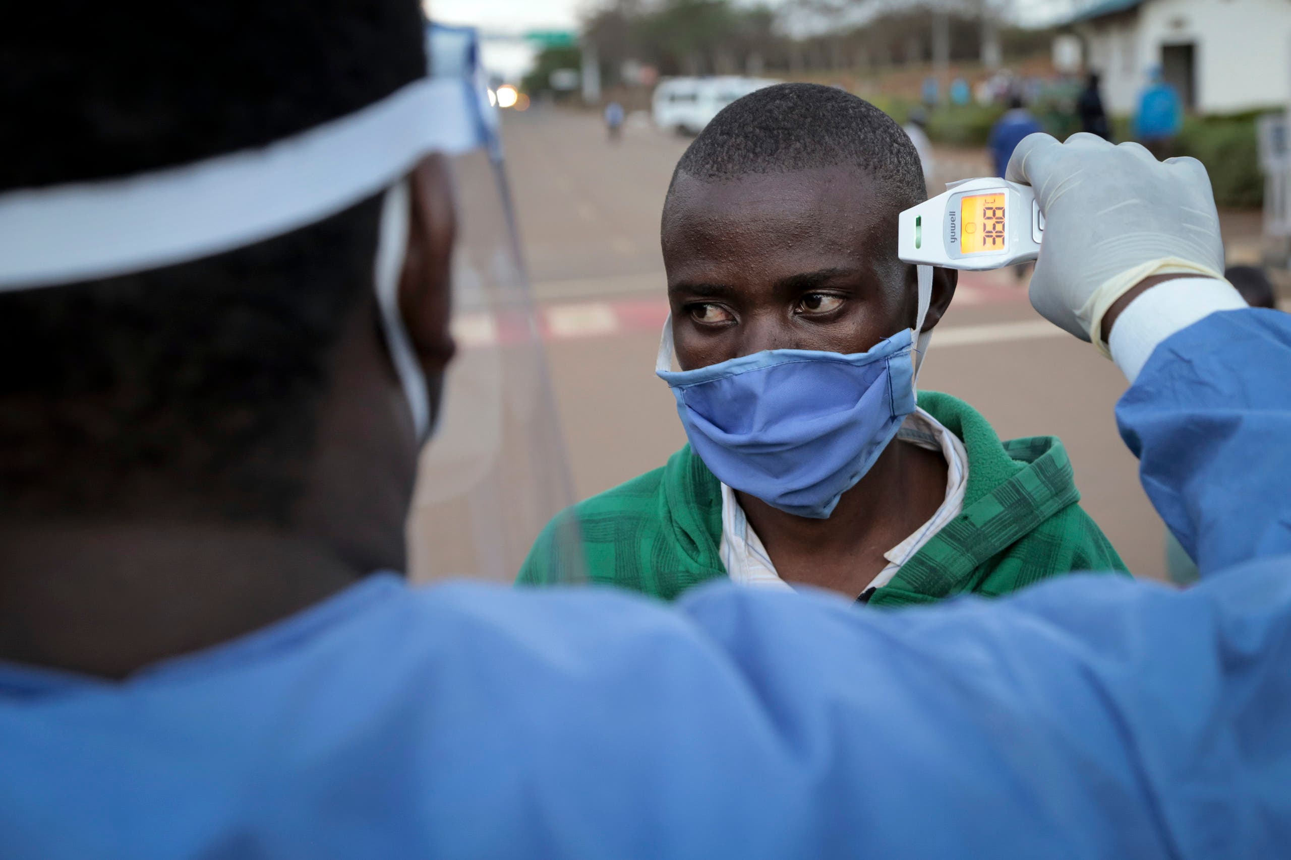 A man is checked for fever as a precaution against the spread of the coronavirus in Rwanda. (AP)