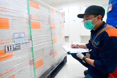 A worker registers boxes containing experimental coronavirus vaccines made by Chinese company Sinovac, after arriving at a facility of state-owned pharmaceutical company Bio Farma. (AP)